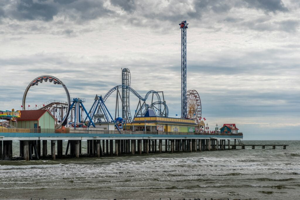 blue and white ferris wheel near body of water during daytime
