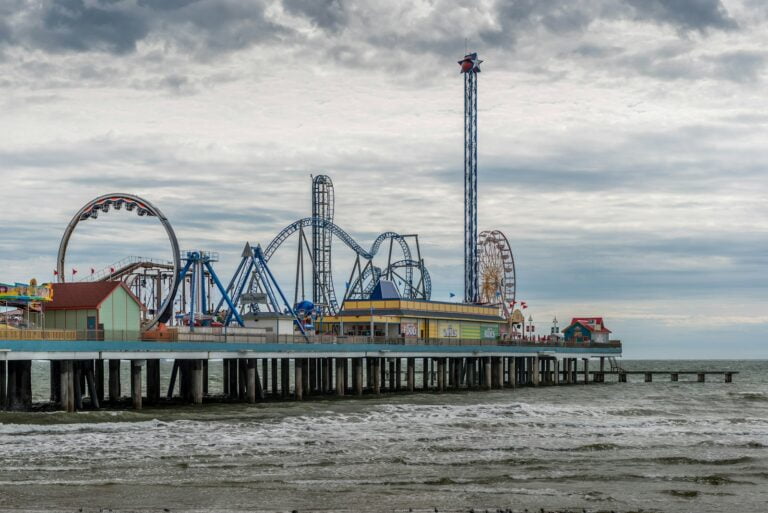 blue and white ferris wheel near body of water during daytime